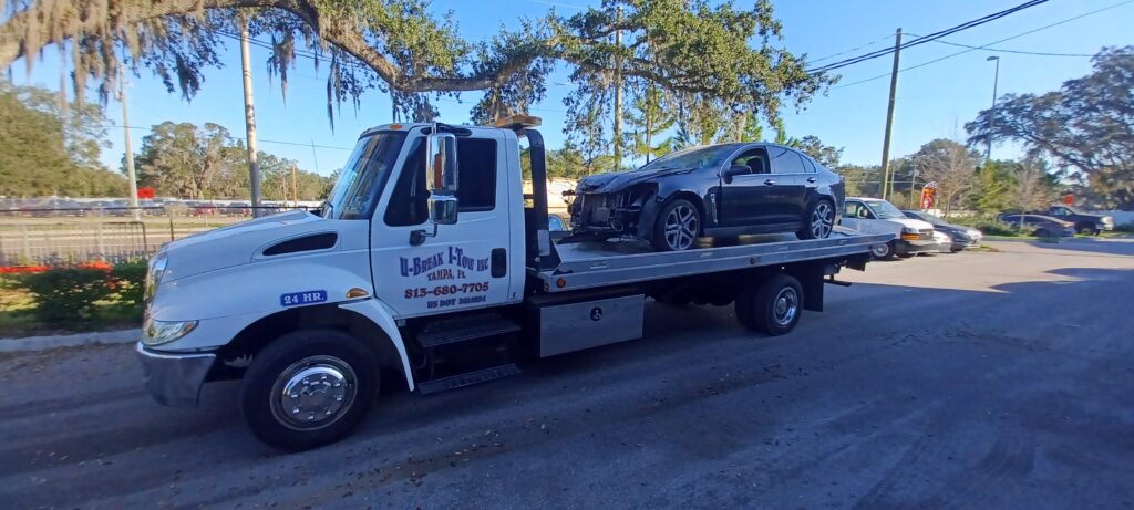 A damaged car towed on a tow truck